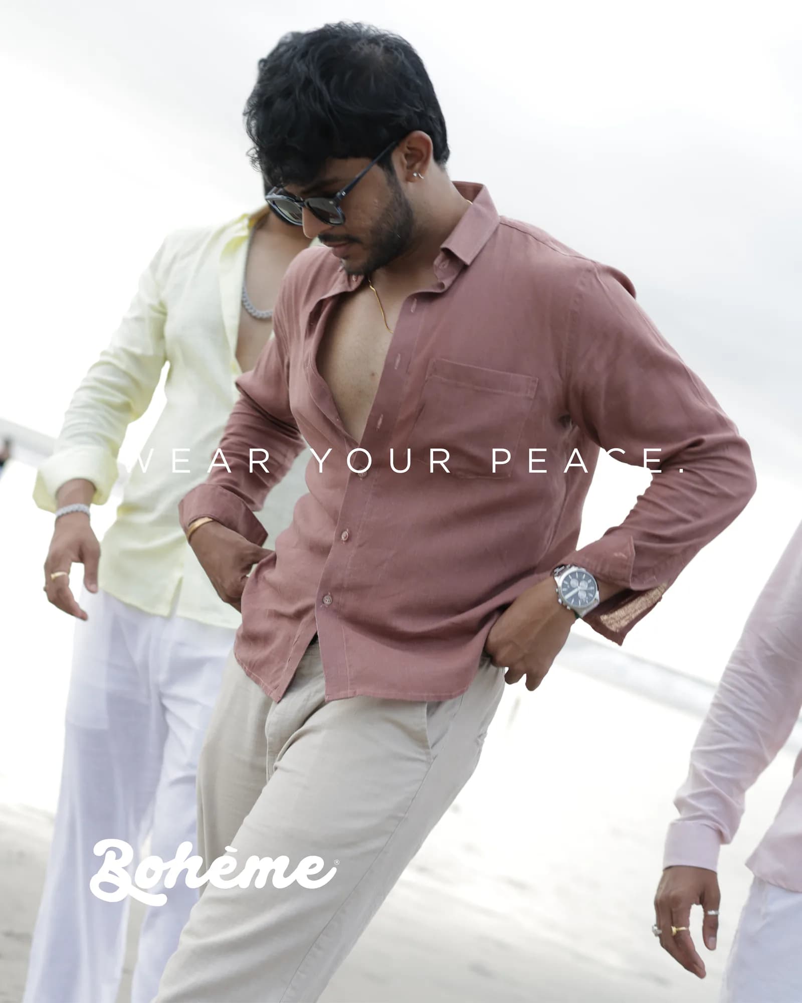 Campaign frame of two models in linen shirting on a beach