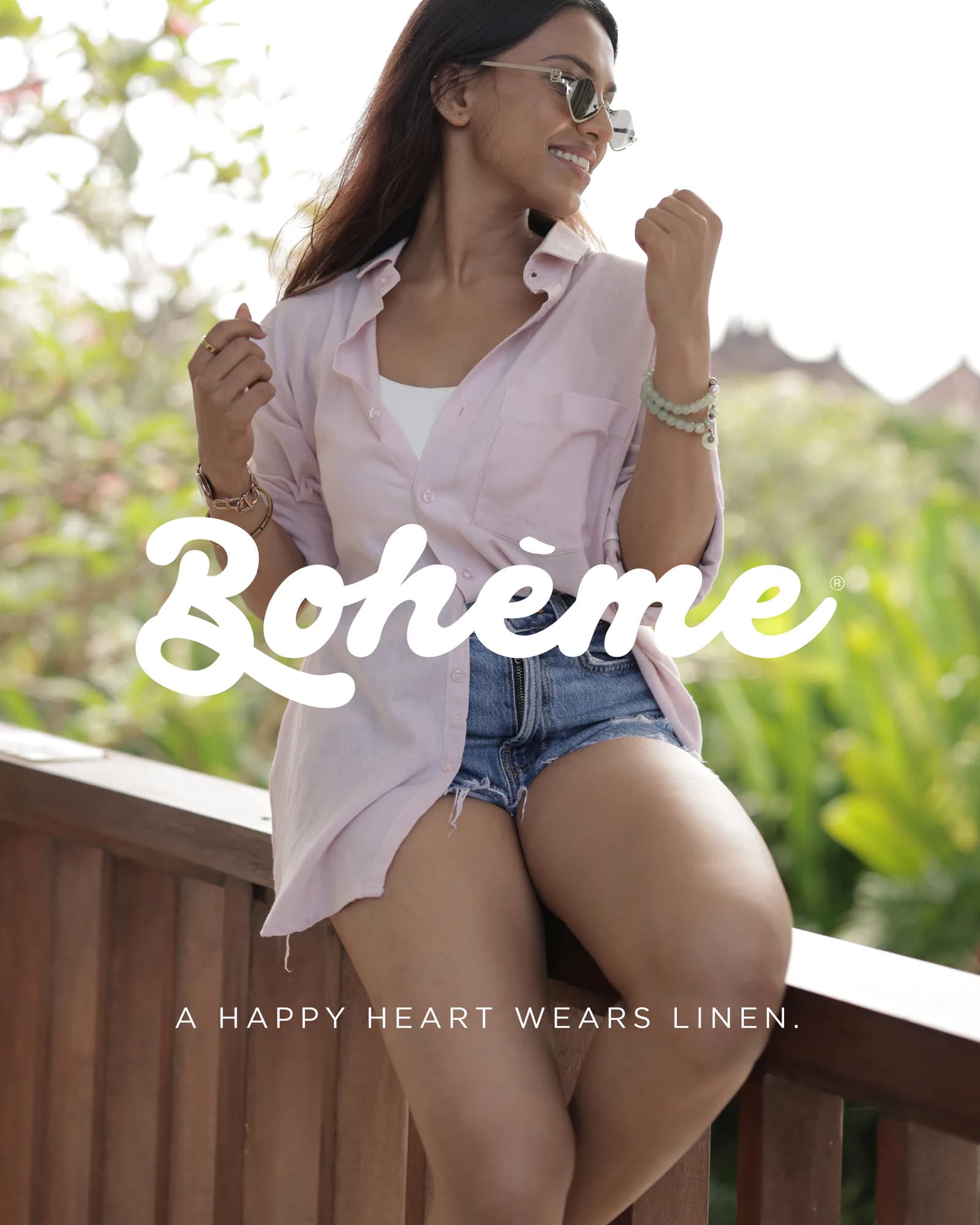 Campaign frame of a model in a linen shirt on a timber terrace