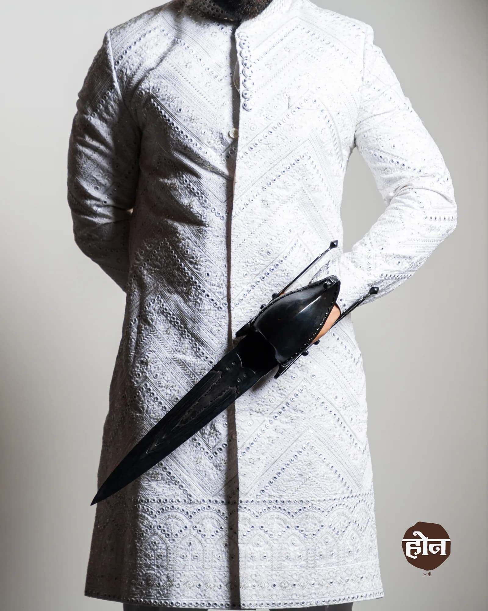 Studio frame of a white embroidered sherwani