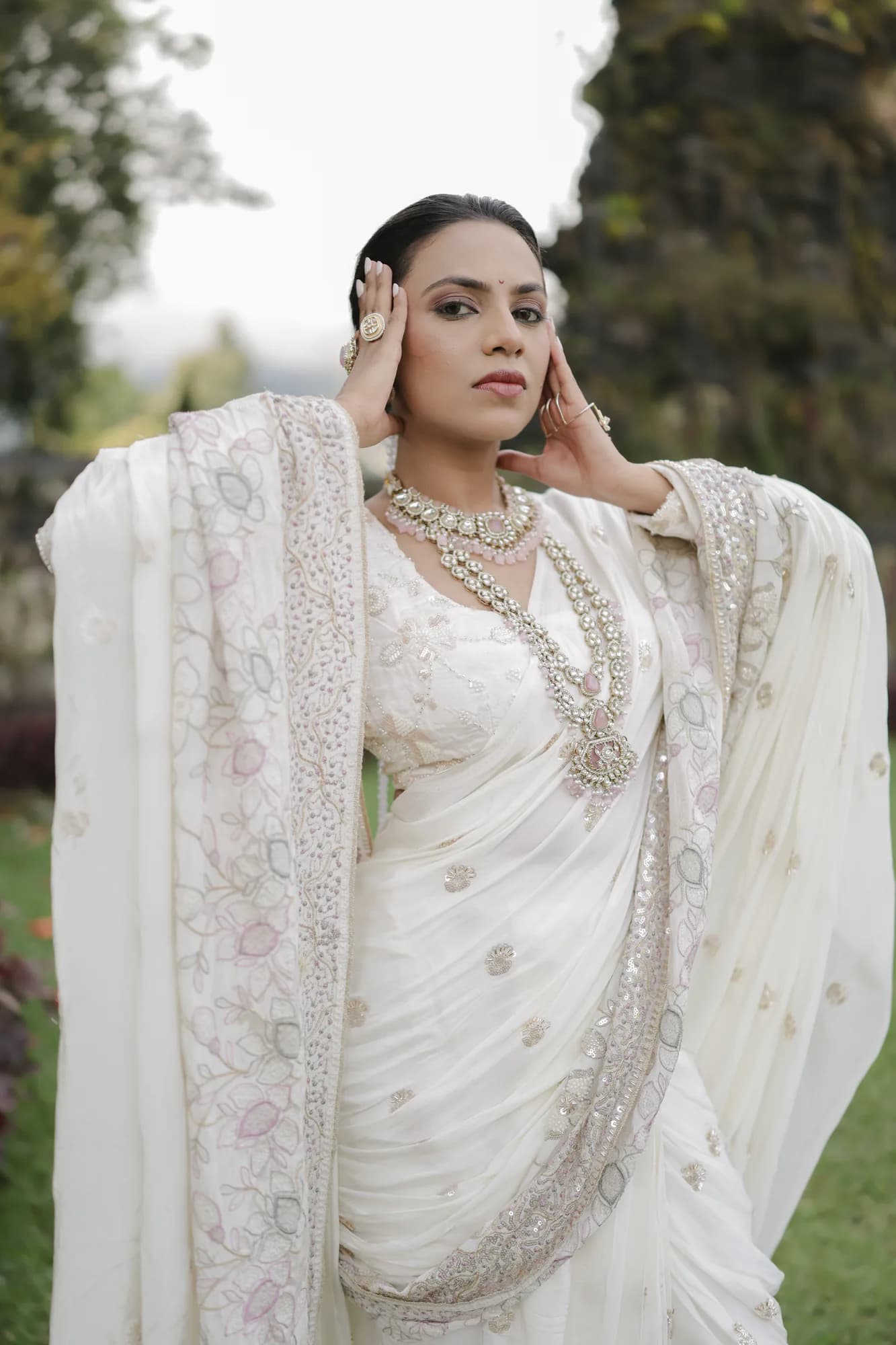 Bride photographed in a garden in ivory occasion wear