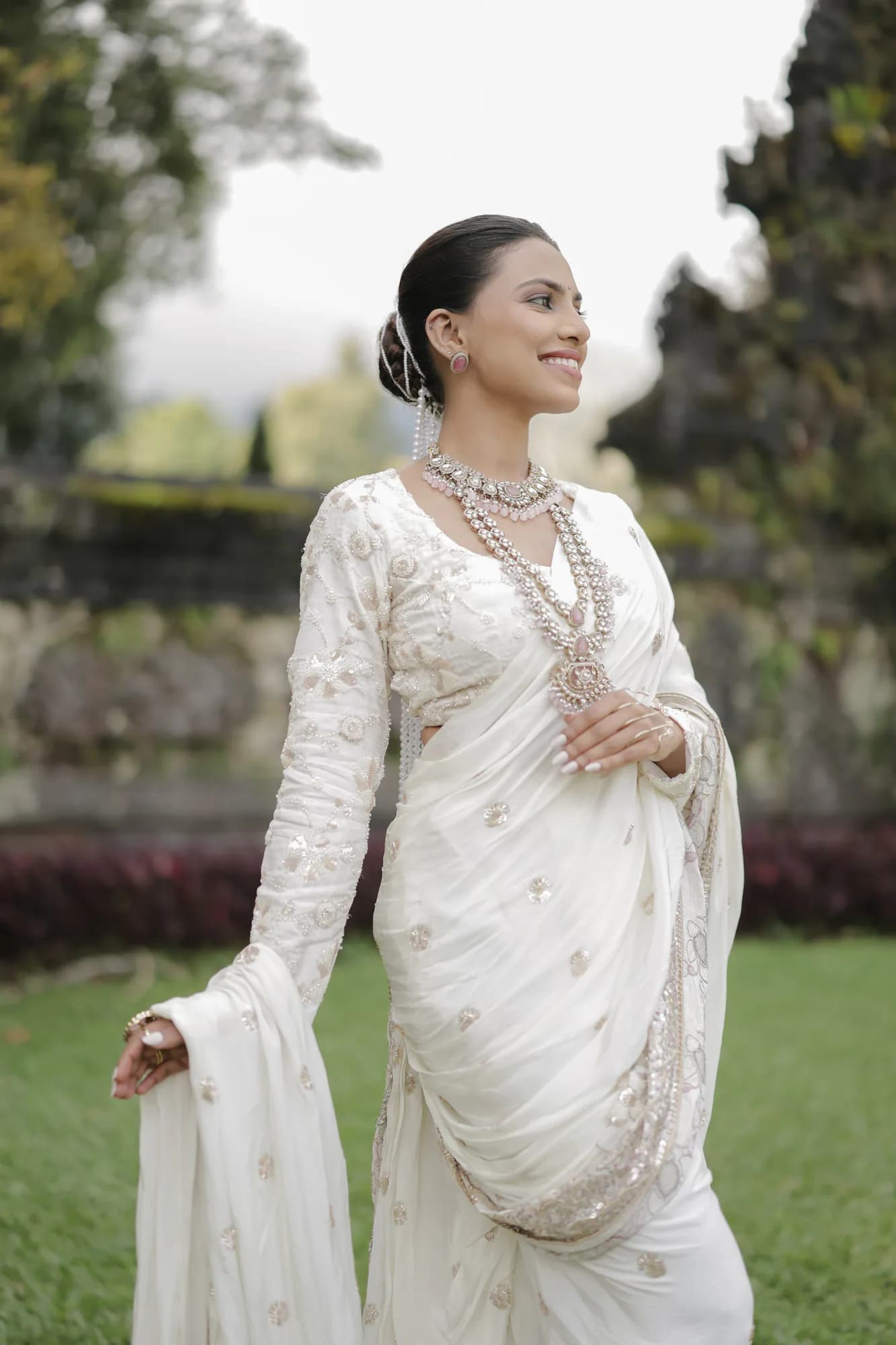Full-length garden portrait in an ivory ceremonial saree