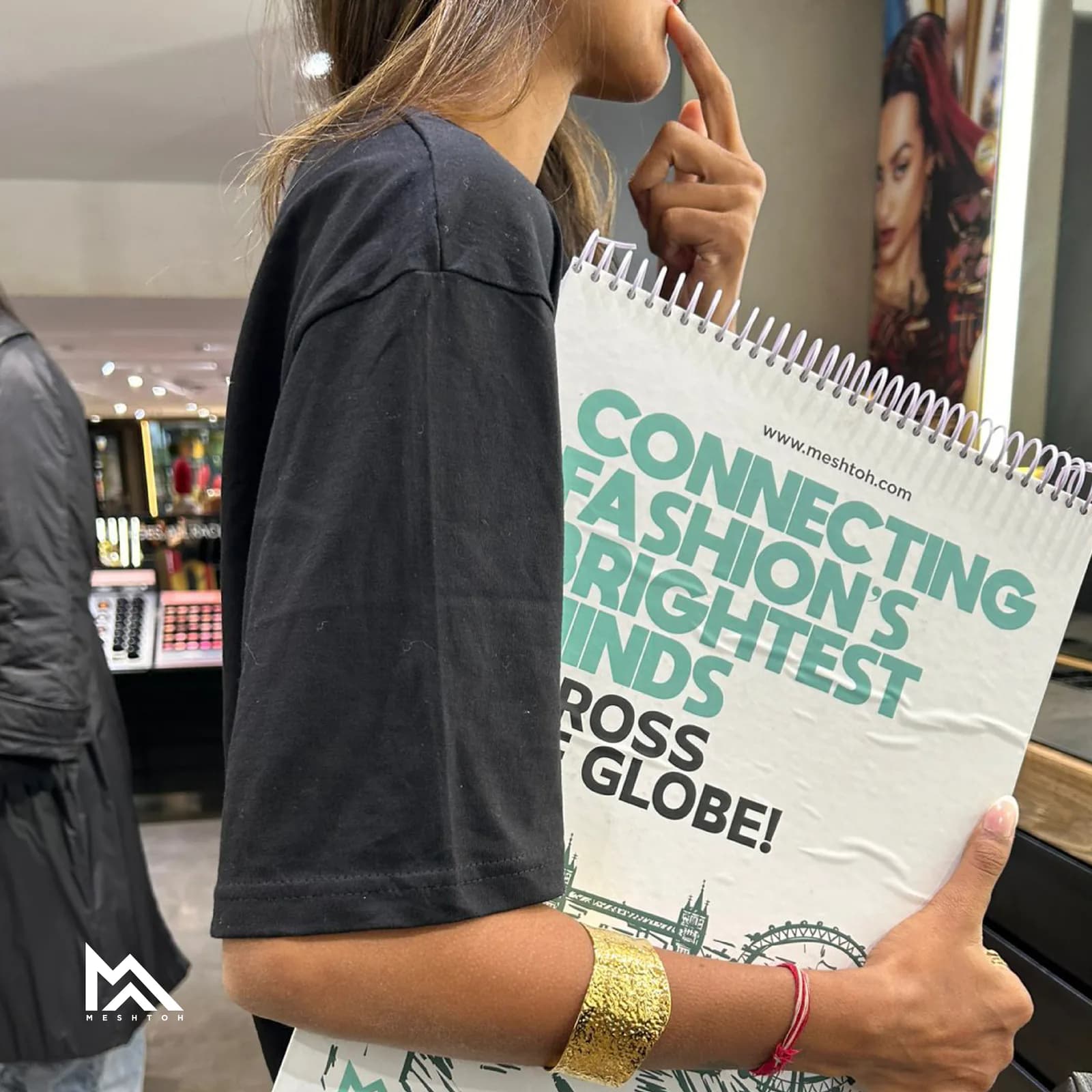 Branded notebook carried through a retail space