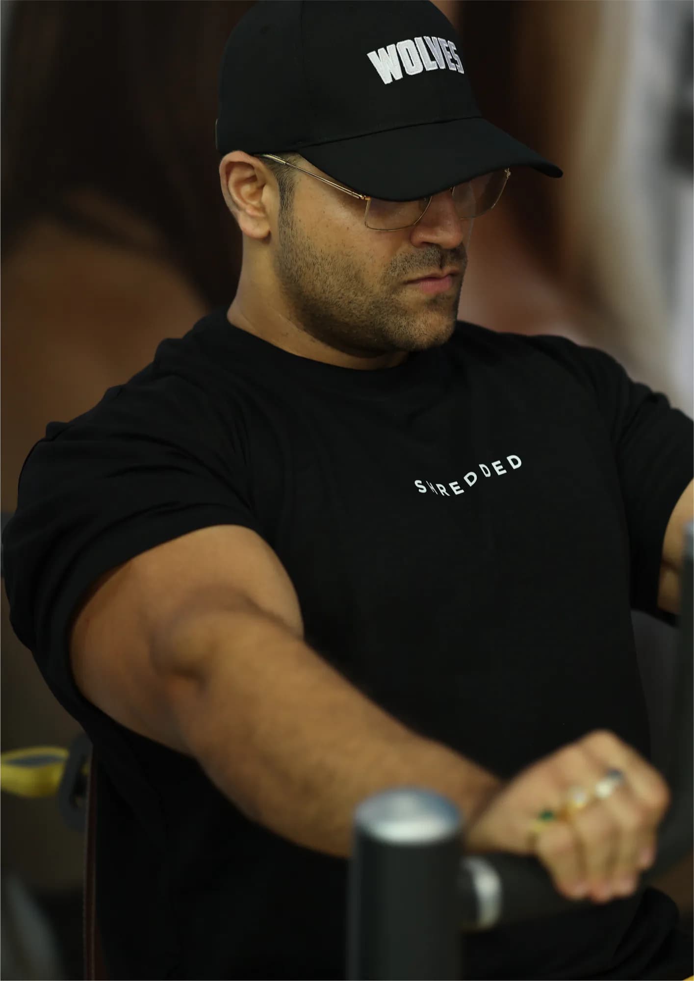 Athlete in a black training tee mid-set in the gym