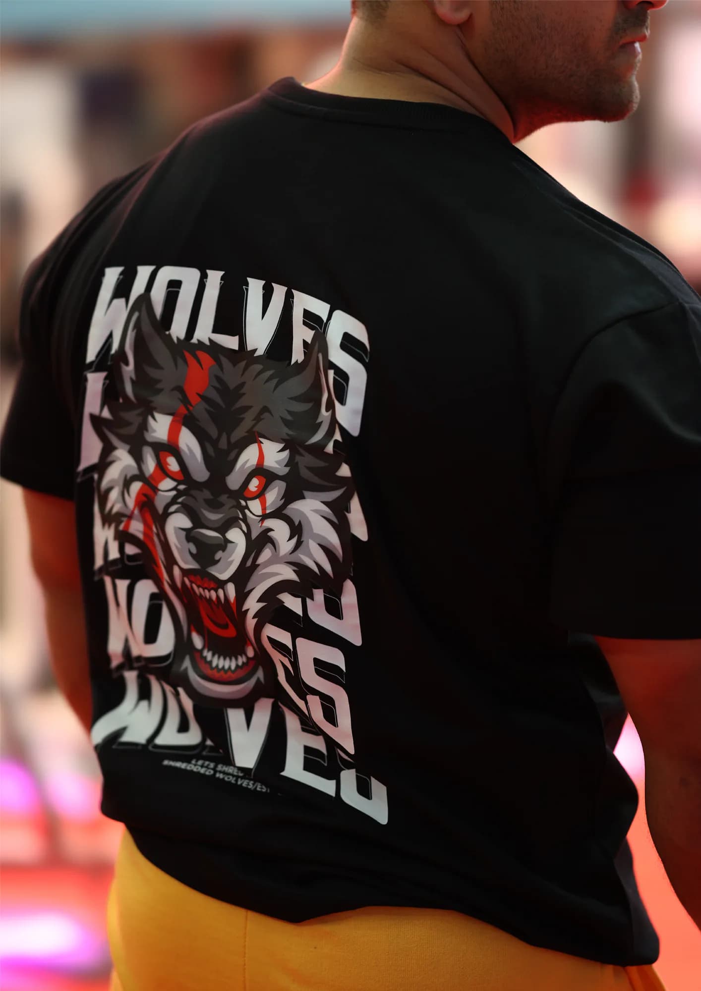 Back view of a wolf-graphic tee photographed on the street